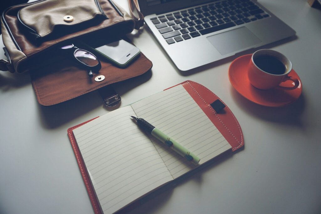 Business Foundation - notebook, laptop, phone, bag, cup of coffee